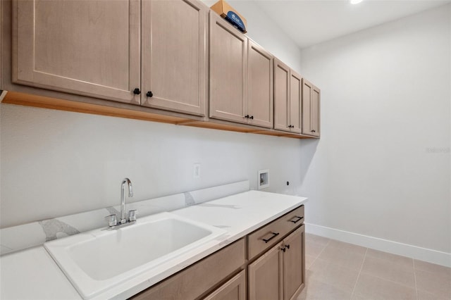 laundry room featuring sink, cabinets, light tile patterned floors, hookup for a washing machine, and electric dryer hookup