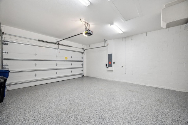 garage with a garage door opener and electric panel