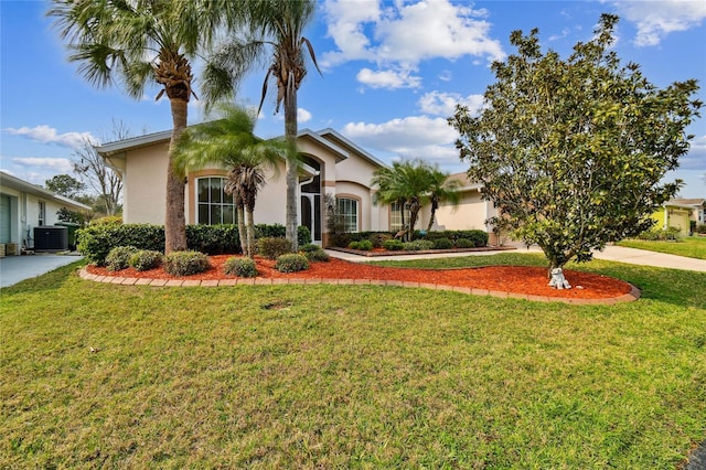 view of front of home with central AC unit and a front lawn