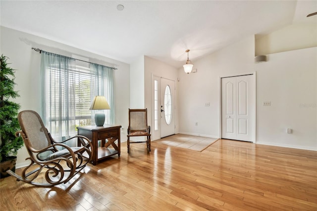 entryway featuring light hardwood / wood-style flooring and vaulted ceiling