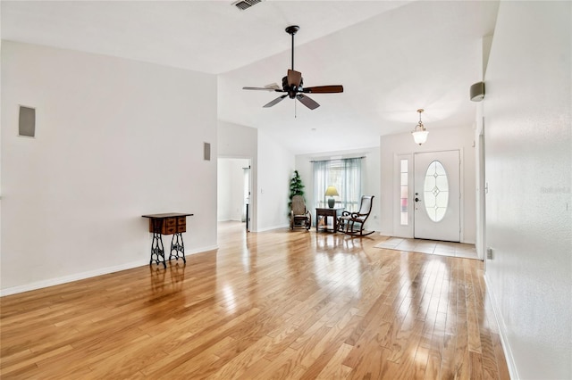 entryway featuring ceiling fan, light wood-type flooring, and high vaulted ceiling