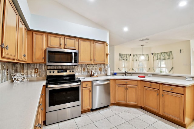 kitchen with appliances with stainless steel finishes, decorative light fixtures, decorative backsplash, vaulted ceiling, and light tile patterned floors