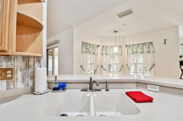 kitchen featuring decorative light fixtures and sink