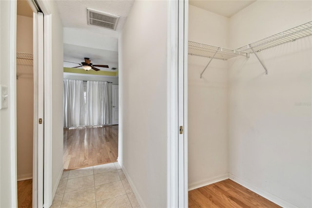 spacious closet with light tile patterned flooring and ceiling fan