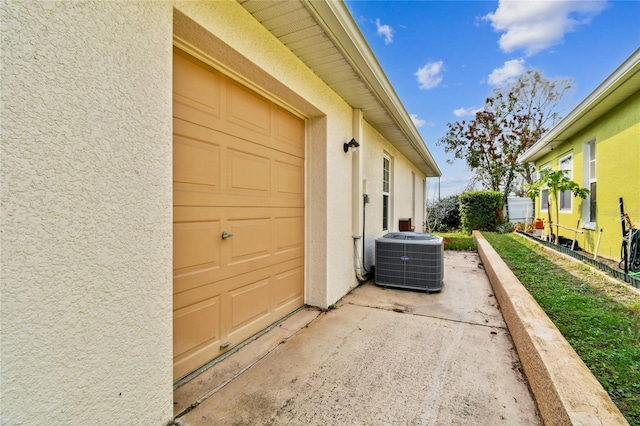 view of home's exterior featuring cooling unit and a garage