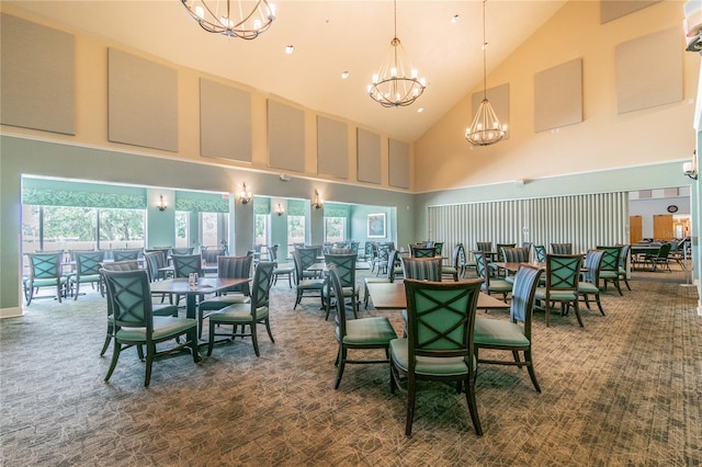 carpeted dining room with high vaulted ceiling and a chandelier