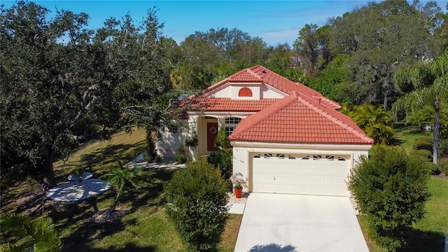 mediterranean / spanish-style house with a garage