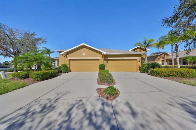 view of front of house featuring concrete driveway, an attached garage, and stucco siding