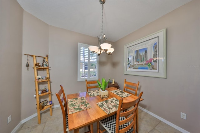 dining room featuring light tile patterned floors, a chandelier, and baseboards