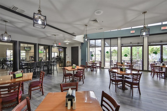 dining area featuring visible vents and wood finished floors