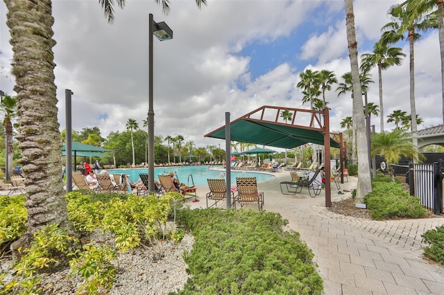 community pool with fence and a patio