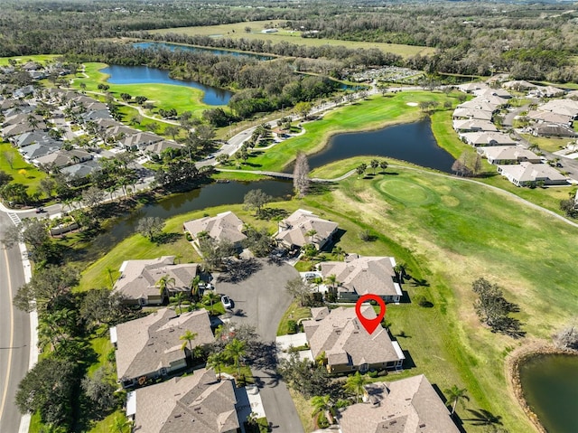 drone / aerial view with a water view, a residential view, and golf course view