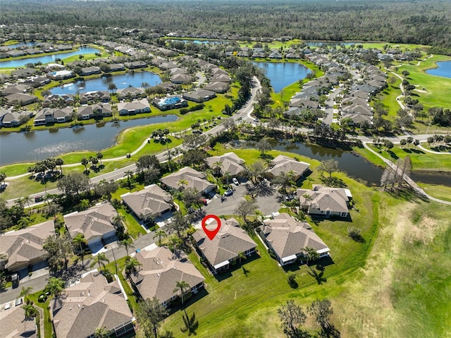 drone / aerial view with a water view and a residential view