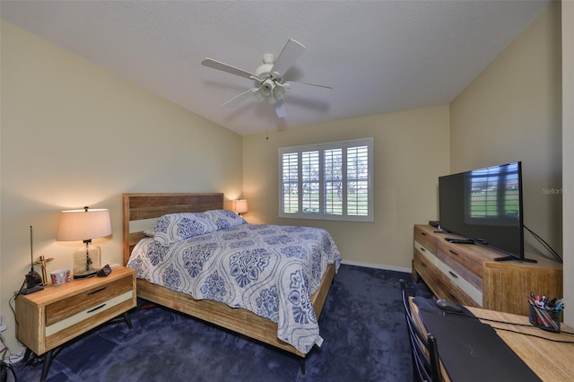 bedroom with ceiling fan, baseboards, and dark colored carpet