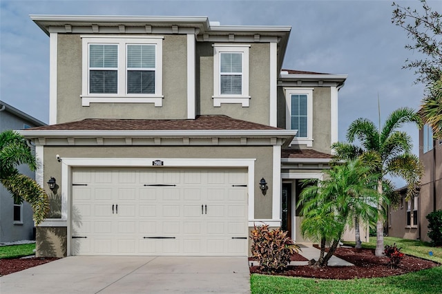 view of front of property with a garage, driveway, and stucco siding