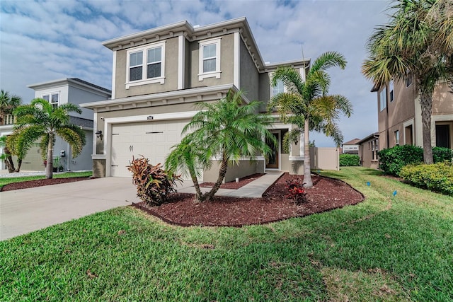 view of front of house featuring driveway, an attached garage, a front lawn, and stucco siding