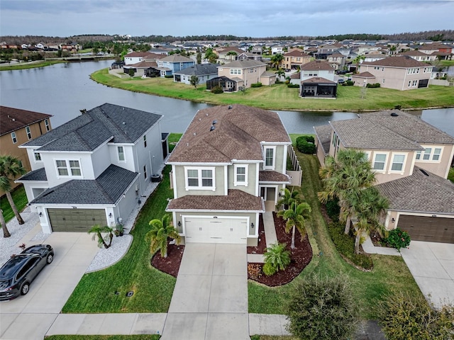 bird's eye view featuring a water view and a residential view