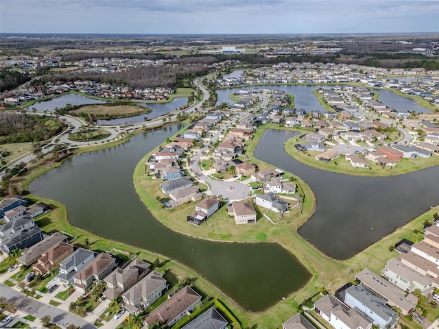 birds eye view of property with a water view and a residential view