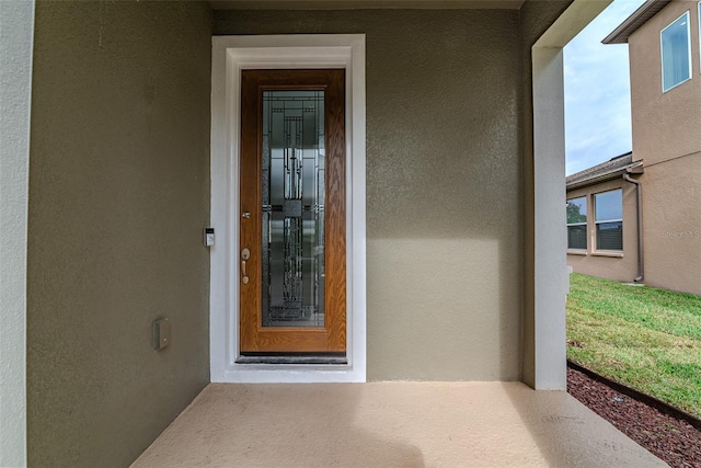 entrance to property with stucco siding