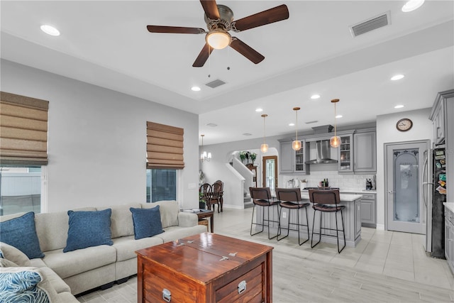 living room featuring a wealth of natural light, recessed lighting, and visible vents