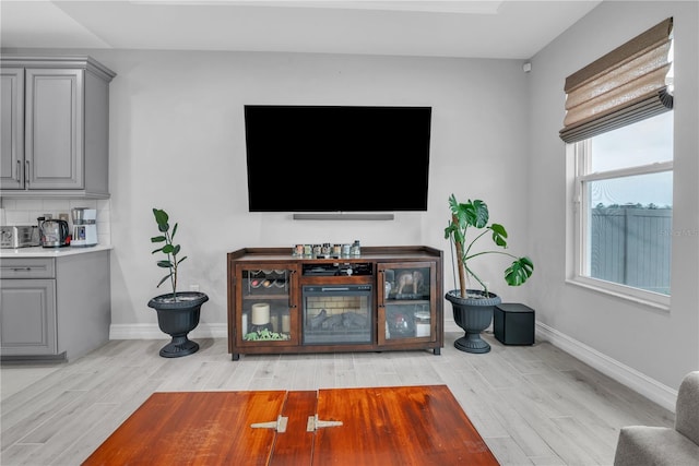 living room with light wood-style flooring and baseboards