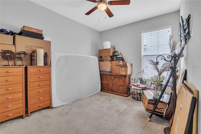 office space featuring a ceiling fan and light colored carpet