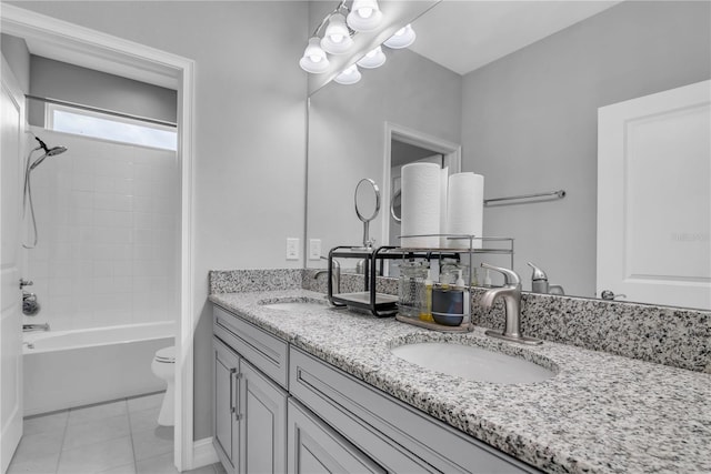 full bathroom featuring double vanity, a sink, toilet, and tile patterned floors