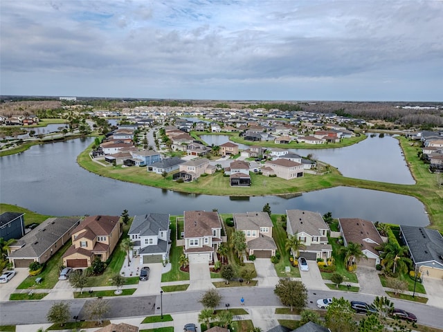 drone / aerial view featuring a residential view and a water view