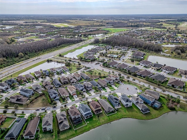 drone / aerial view with a residential view and a water view