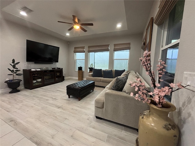 29011 Trevi Pl, Wesley Chapel, FL 33543 - living room featuring ceiling fan, light wood-style floors, recessed lighting, and a tray ceiling