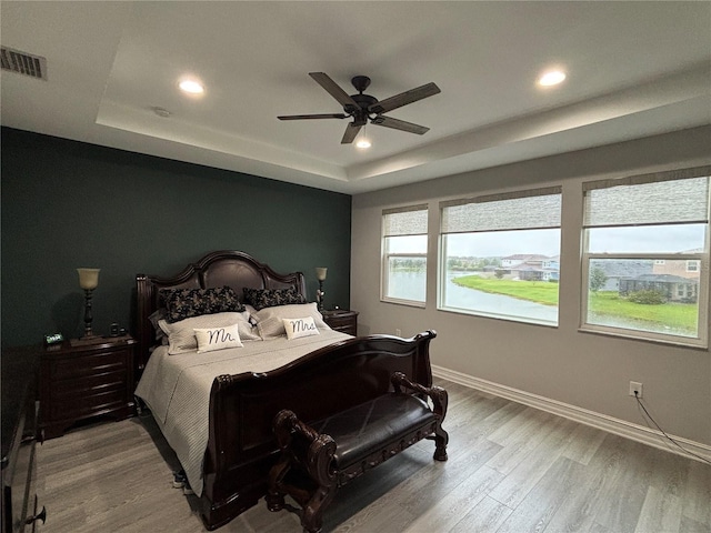 29011 Trevi Pl, Wesley Chapel, FL 33543 - bedroom featuring a raised ceiling, recessed lighting, wood finished floors, and ceiling fan