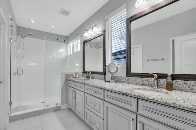 29011 Trevi Pl, Wesley Chapel, FL 33543 - bathroom with a stall shower, double vanity, tile patterned floors, and recessed lighting