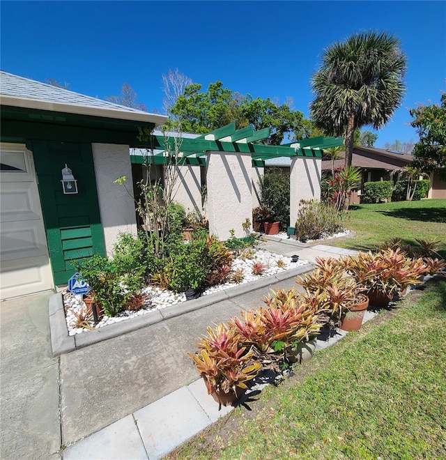 exterior space with a front lawn and stucco siding