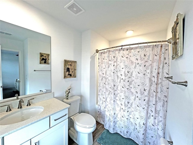 bathroom with toilet, a shower with shower curtain, vanity, and visible vents