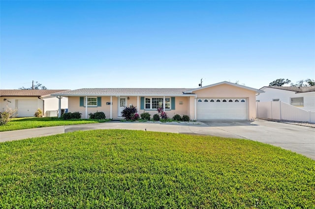 ranch-style house with stucco siding, concrete driveway, an attached garage, fence, and a front lawn