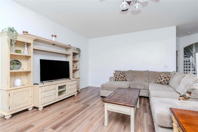 living room with ceiling fan and light hardwood / wood-style flooring