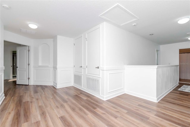 spare room with light hardwood / wood-style flooring