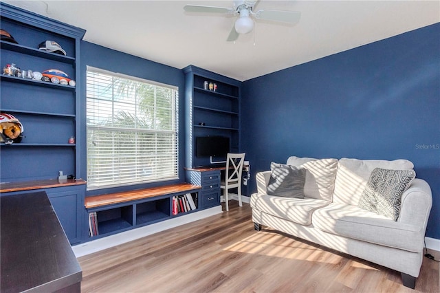 living room featuring ceiling fan and wood-type flooring