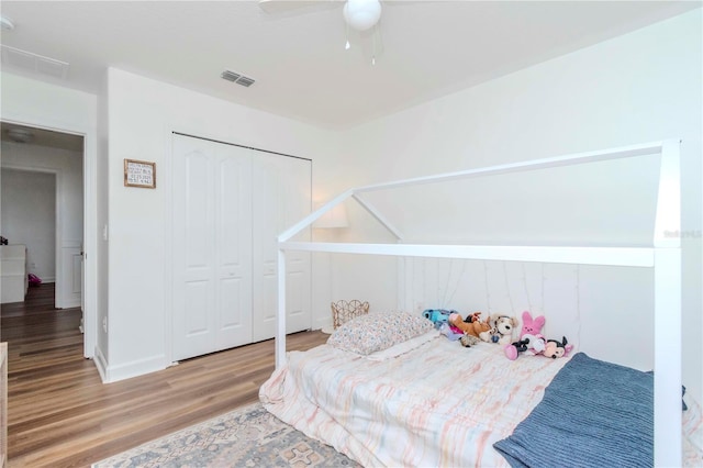bedroom with a closet, ceiling fan, and wood-type flooring