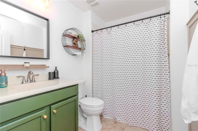 bathroom featuring vanity, toilet, tile patterned floors, and walk in shower