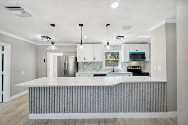 kitchen featuring stainless steel appliances, light countertops, visible vents, decorative backsplash, and a sink