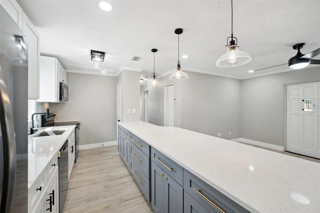 kitchen with black microwave, dishwashing machine, visible vents, white cabinetry, and crown molding