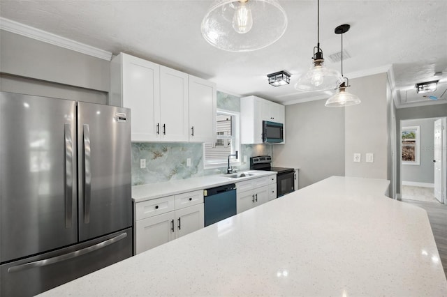 kitchen featuring stainless steel appliances, backsplash, ornamental molding, white cabinetry, and a sink