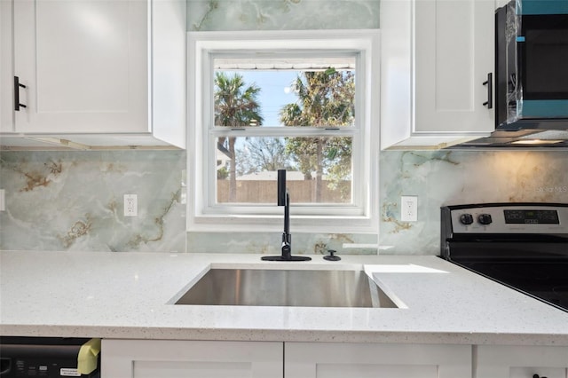 kitchen featuring tasteful backsplash, white cabinets, dishwashing machine, stainless steel electric range oven, and a sink