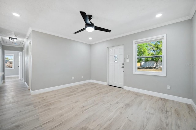 entrance foyer featuring crown molding, a healthy amount of sunlight, and baseboards