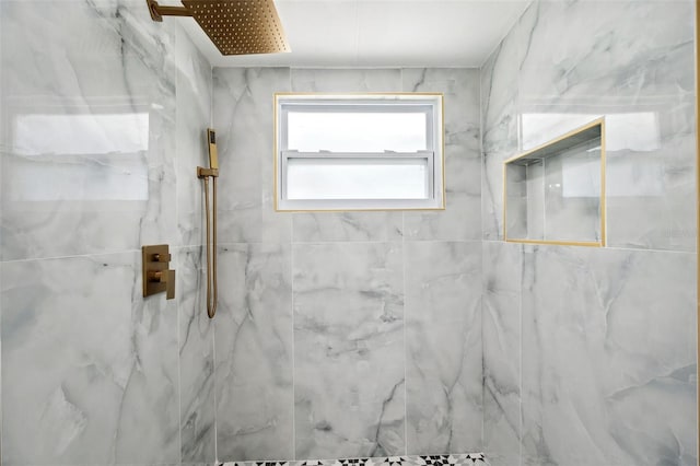 full bath featuring a marble finish shower