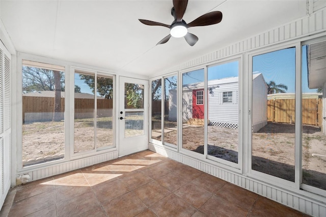 unfurnished sunroom with a wealth of natural light and ceiling fan