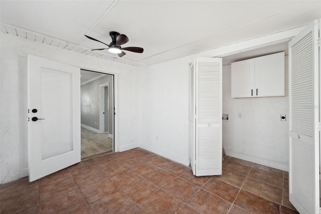 unfurnished bedroom featuring ceiling fan and baseboards