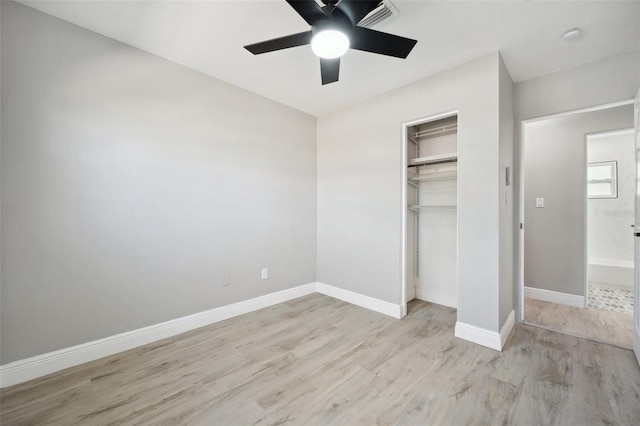 unfurnished bedroom featuring light wood finished floors, a closet, visible vents, a ceiling fan, and baseboards