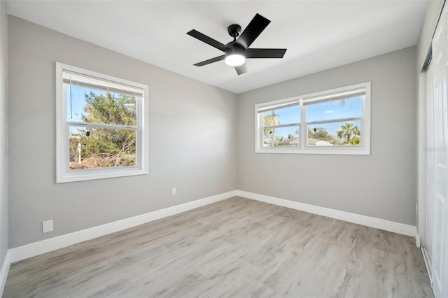 unfurnished room with light wood-style flooring, baseboards, and ceiling fan